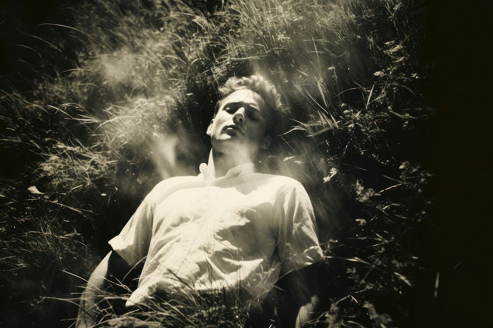 A man laying comfortably in the grass photography portrait outdoors. AI generated Image by rawpixel.