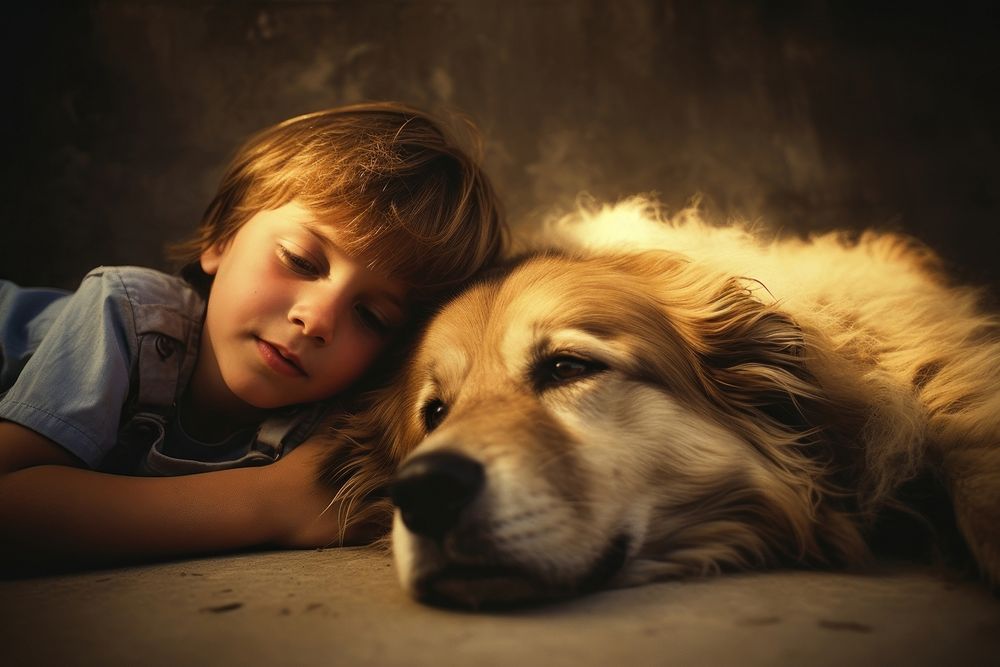 A little boy laying on the floor next to a dog photography portrait mammal. 