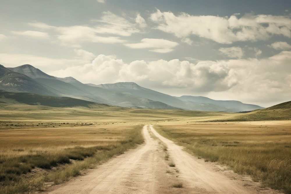 A dirt road on a cloudy day landscape mountain outdoors. AI generated Image by rawpixel.