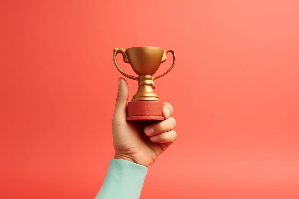 Hand showing up holding gold cup trophy achievement investment success. AI generated Image by rawpixel.