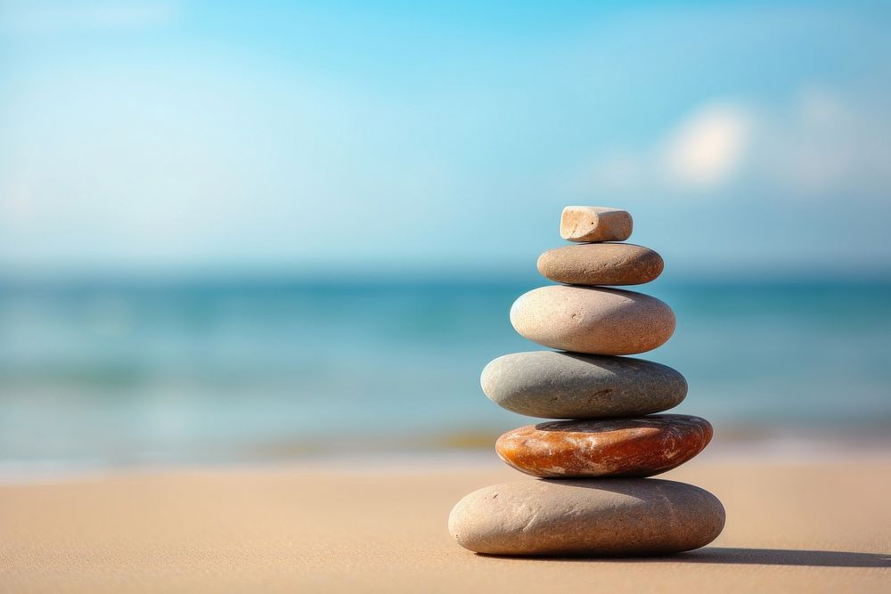 Stones stacked in the sand pebble sea tranquility. AI generated Image by rawpixel.