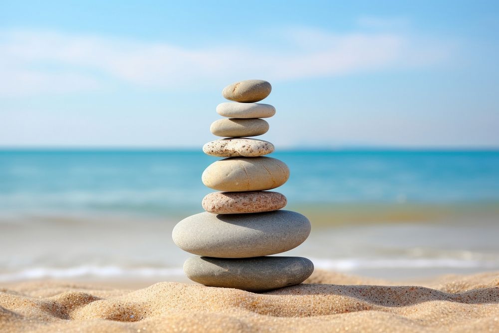 Stones stacked in the sand pebble sea tranquility. AI generated Image by rawpixel.