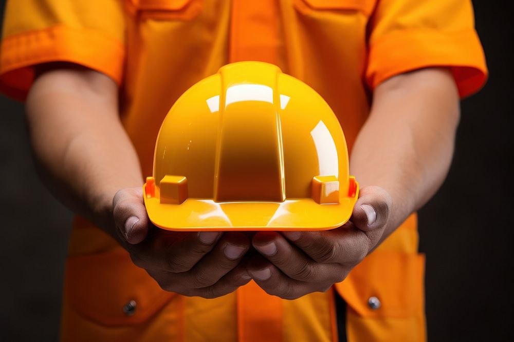 A person holding a yellow hard hat hardhat helmet construction. AI generated Image by rawpixel.