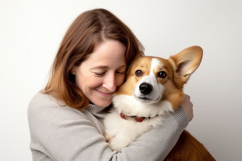 American middle age woman hugging pembroke welsh corgi pet portrait looking. AI generated Image by rawpixel.