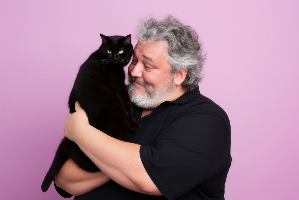 American middle age chubby man hugging black cat pet portrait mammal. AI generated Image by rawpixel.