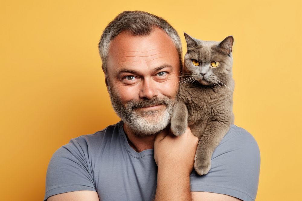 American middle age man hugging british shorthair cat pet portrait animal. AI generated Image by rawpixel.