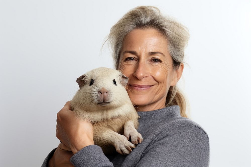 American middle age woman hugging guinea pig portrait animal mammal. AI generated Image by rawpixel.