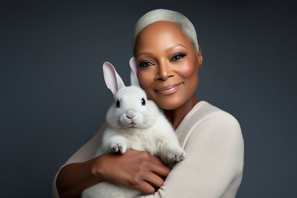 African american middle age woman hugging rabbit portrait animal mammal. AI generated Image by rawpixel.