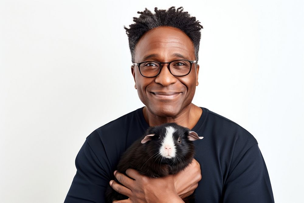 African american middle age man hugging guinea pig portrait glasses mammal. AI generated Image by rawpixel.