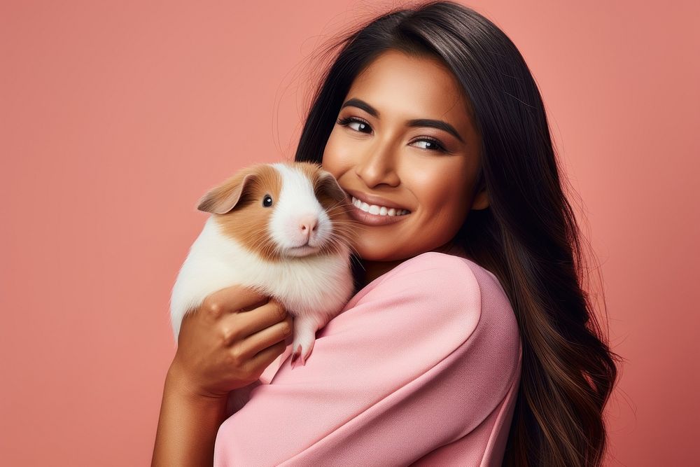 Asian woman hugging guinea pig portrait looking animal. AI generated Image by rawpixel.