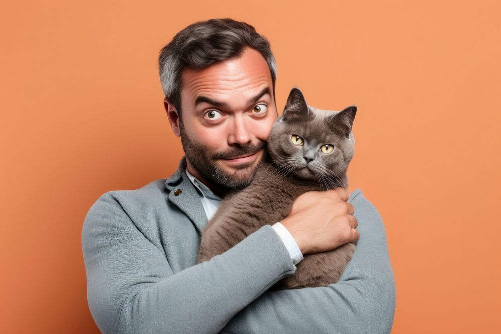 Middle east middle age man hugging british shorthair cat pet portrait animal. AI generated Image by rawpixel.