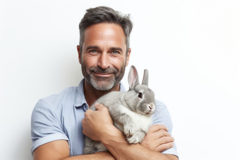 Spainish middle age man hugging rabbit animal mammal person. AI generated Image by rawpixel.