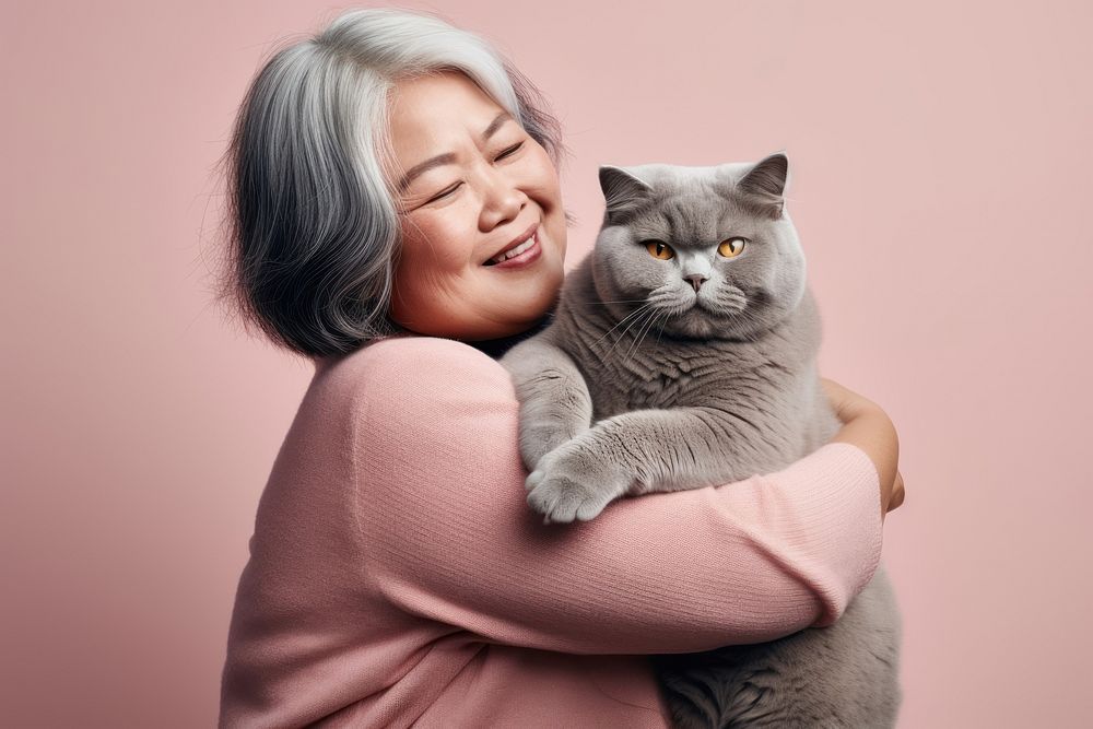 Thai middle age woman hugging british shorthair cat pet portrait mammal. AI generated Image by rawpixel.
