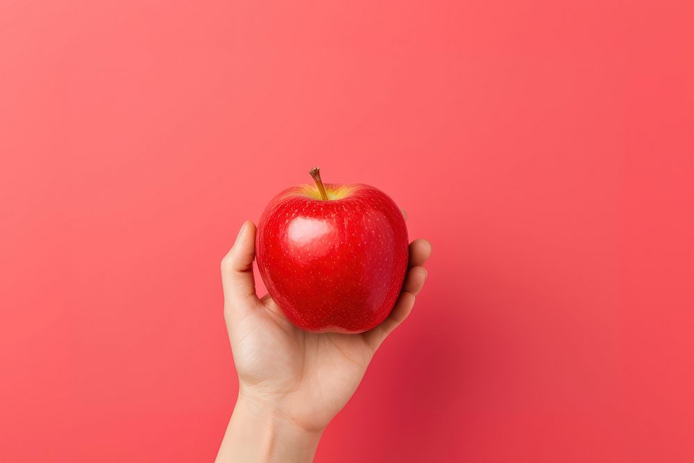 Hand holding red apple fruit plant food. AI generated Image by rawpixel.