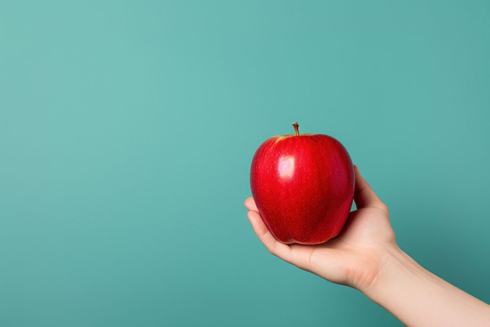 Hand holding red apple fruit plant food. AI generated Image by rawpixel.