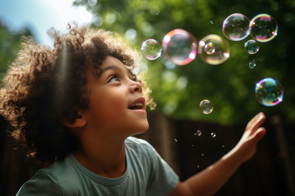 Latin cuban boy blowing bubbles while playing in playground portrait summer child. AI generated Image by rawpixel.