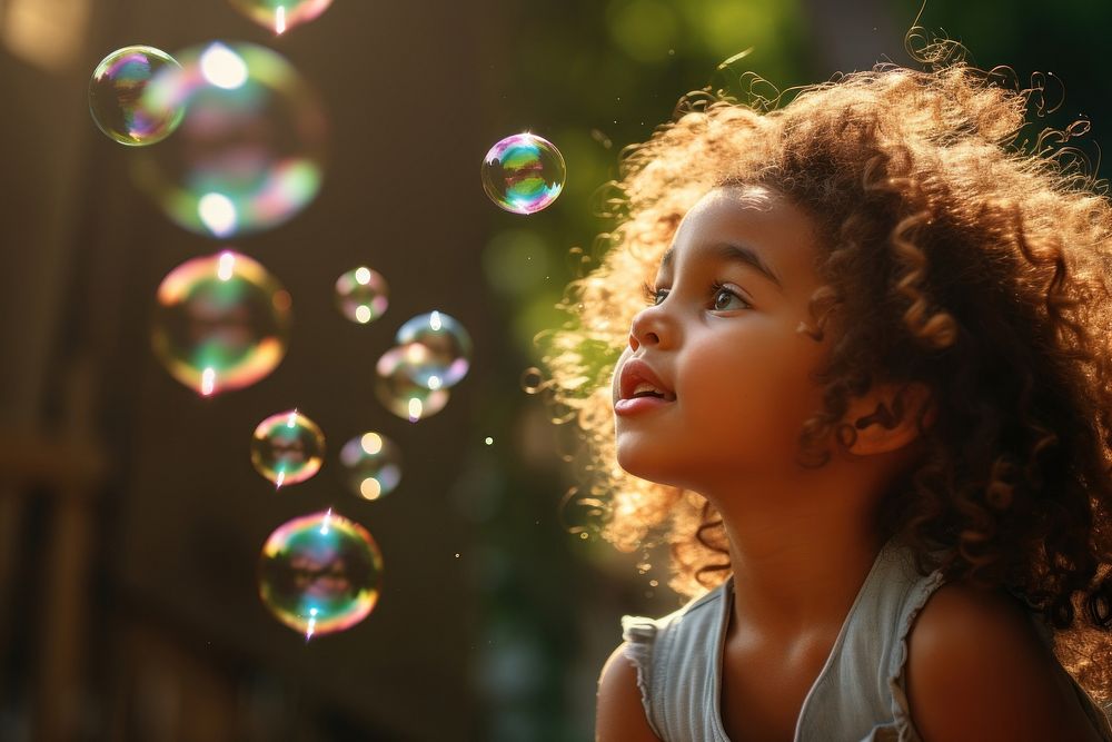 Latin cuban girl blowing bubbles while playing in playground portrait outdoors summer. AI generated Image by rawpixel.