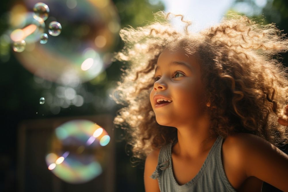 Latin cuban girl blowing bubbles while playing in playground portrait summer child. AI generated Image by rawpixel.
