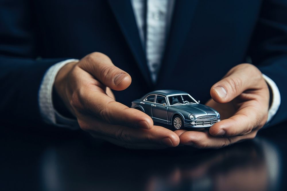 Businessman holding a car model vehicle finger wheel. AI generated Image by rawpixel.
