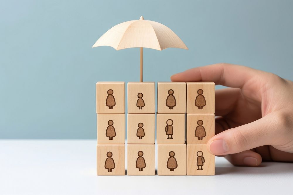 Hand holding umbrella wood block cover Insurance icon protection sheltering shielding. AI generated Image by rawpixel.