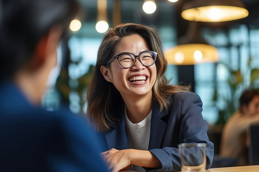 Thai businesswoman laughing glasses meeting. AI generated Image by rawpixel.