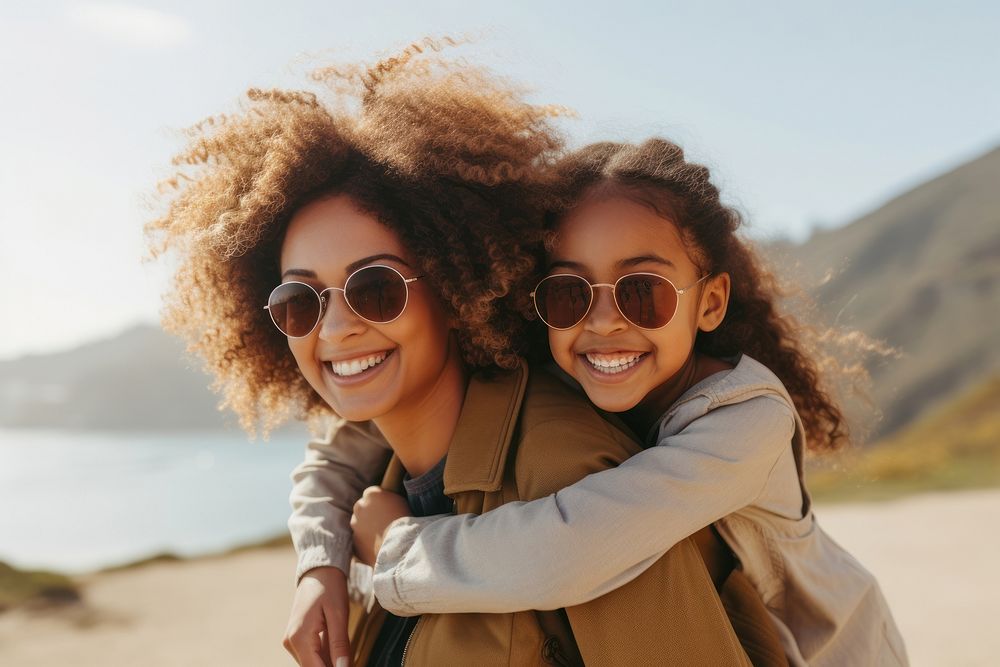 Woman giving a piggyback ride to her girl sunglasses portrait adult. AI generated Image by rawpixel.