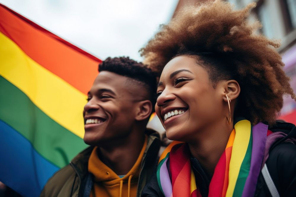 Black couple with rainbow flag celebration laughing portrait. AI generated Image by rawpixel.