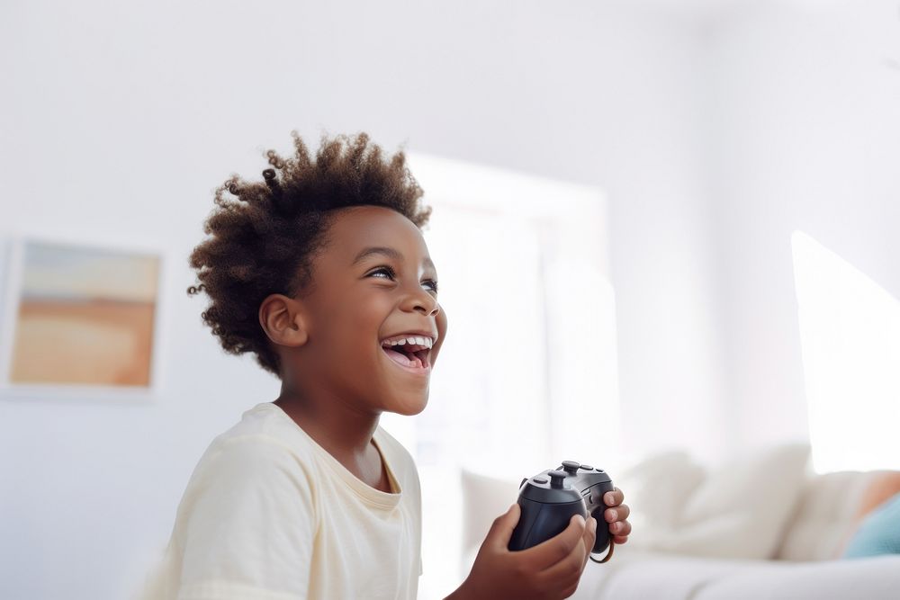 Black kid holding joystick smile photo happy. AI generated Image by rawpixel.