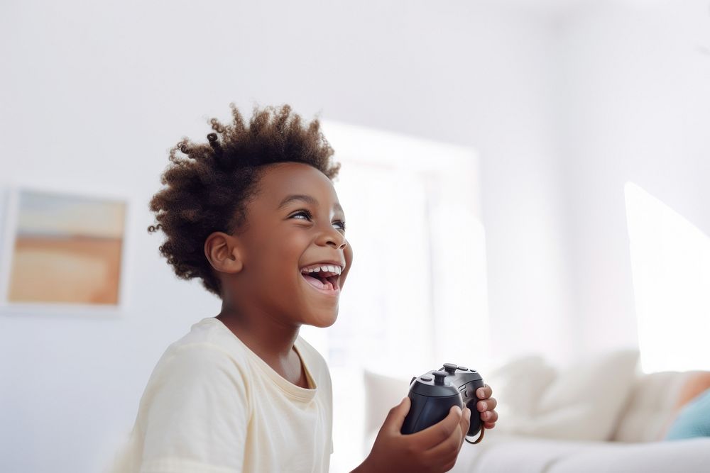 Black kid holding joystick smile photo happy. 