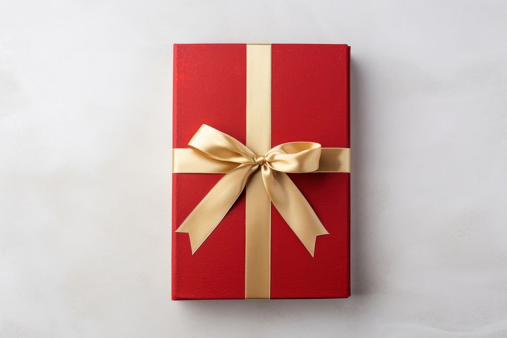 Book with golden ribbon gift red high angle view. AI generated Image by rawpixel.