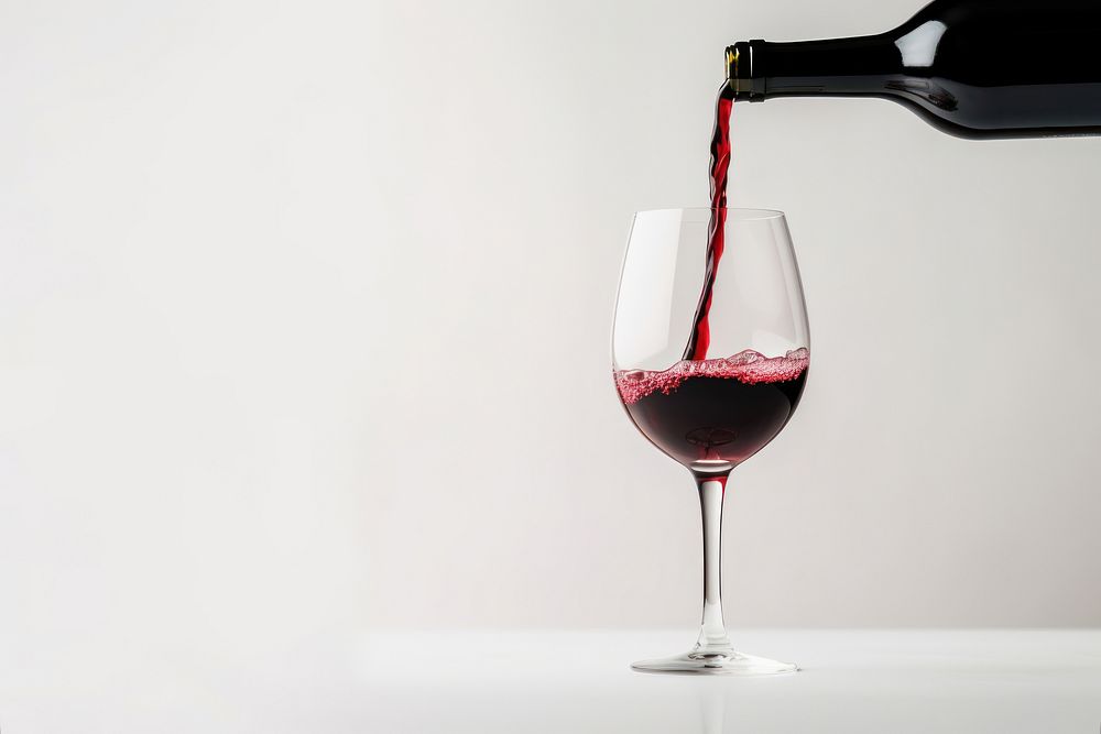 Pouring red wine from bottle glass drink refreshment. AI generated Image by rawpixel.