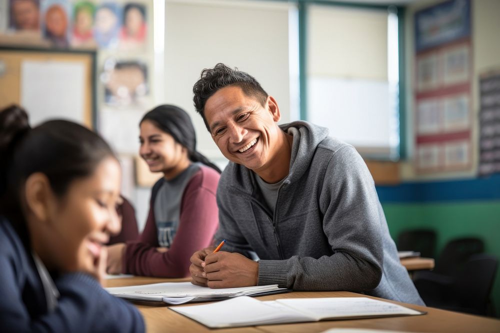 Tutor teaching teenage Hispanic student classroom smiling. AI generated Image by rawpixel.