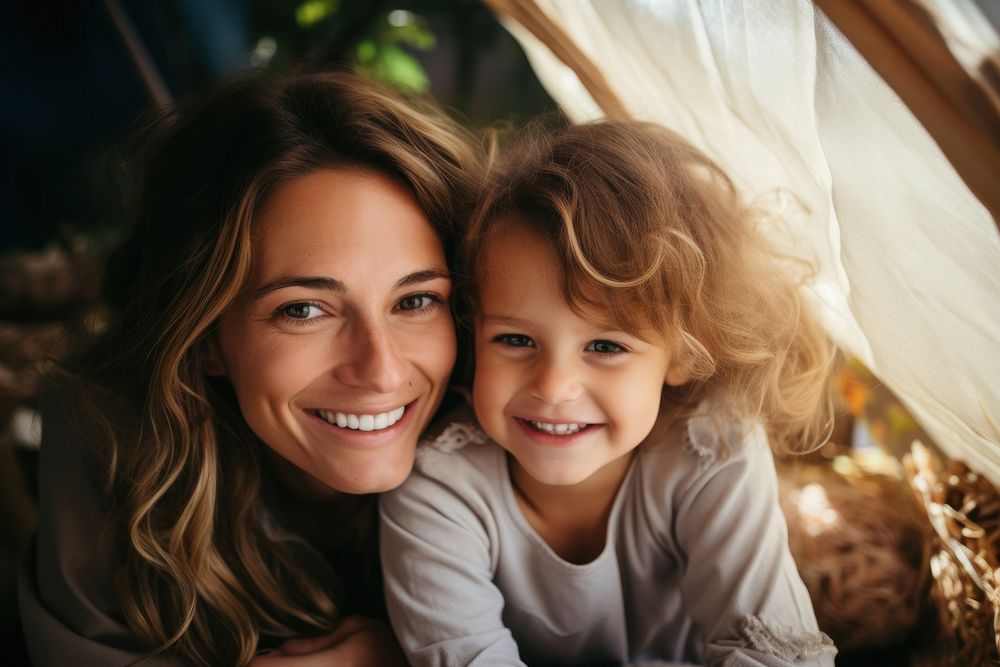 Happy family mother and daughter playing at home in a tent photography laughing portrait. 