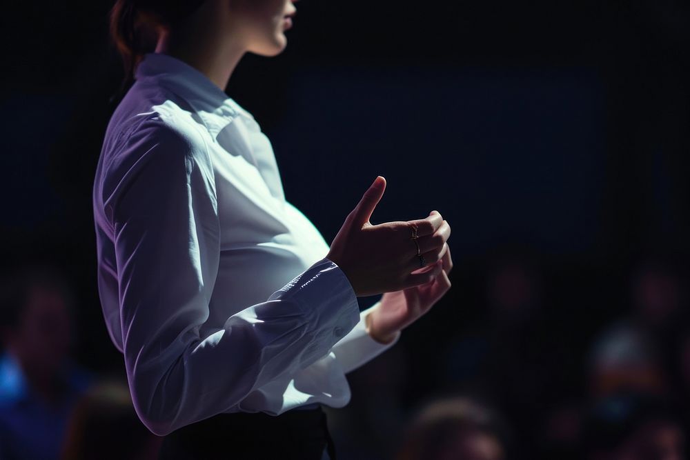 Woman standing presenting project in conference hall performance midsection audience. AI generated Image by rawpixel.