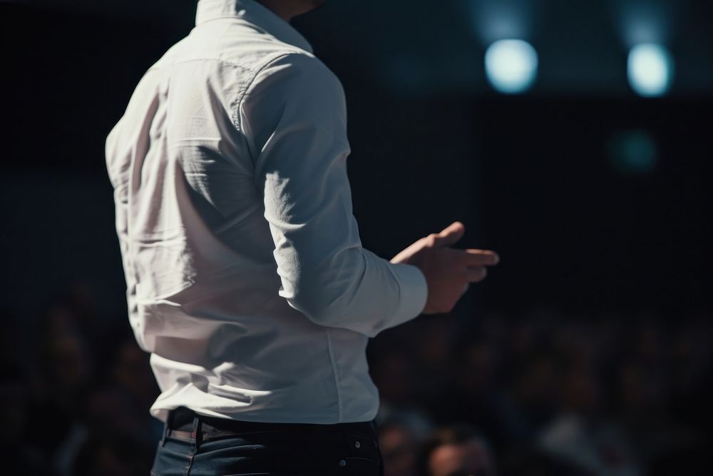 Man standing presenting project in conference hall audience adult black. AI generated Image by rawpixel.