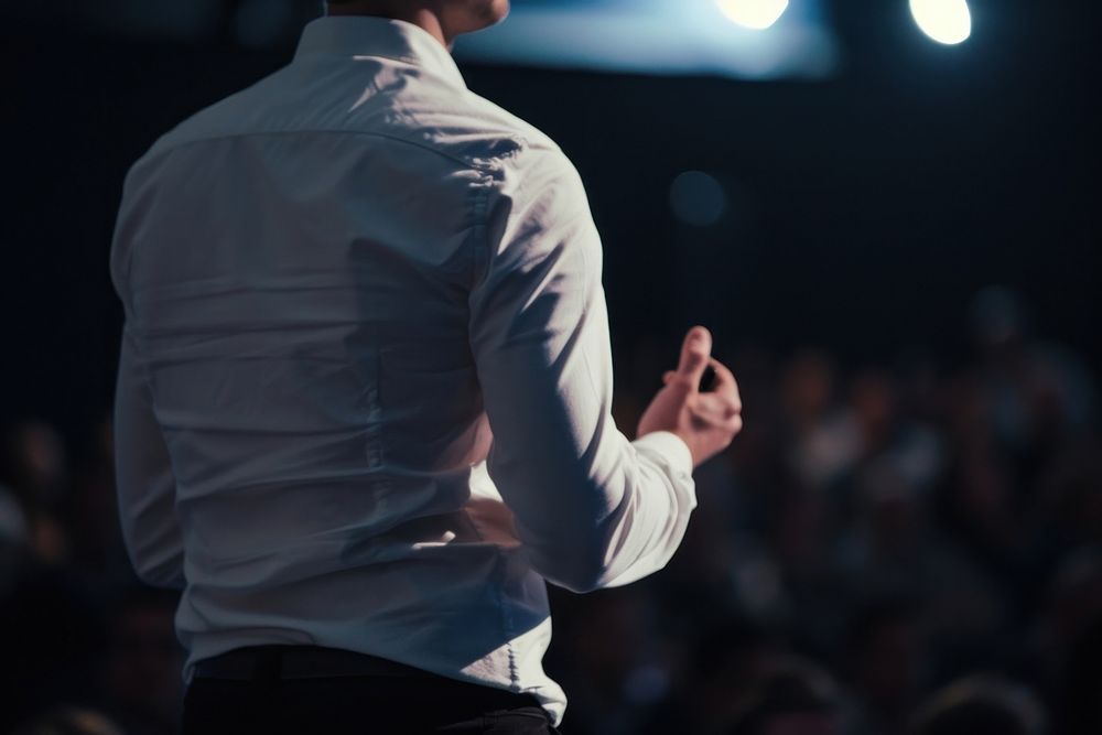 Man standing presenting project in conference hall adult shirt hand. AI generated Image by rawpixel.