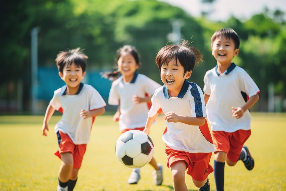 Diverse school kids playing soccer football outdoors sports. AI generated Image by rawpixel.