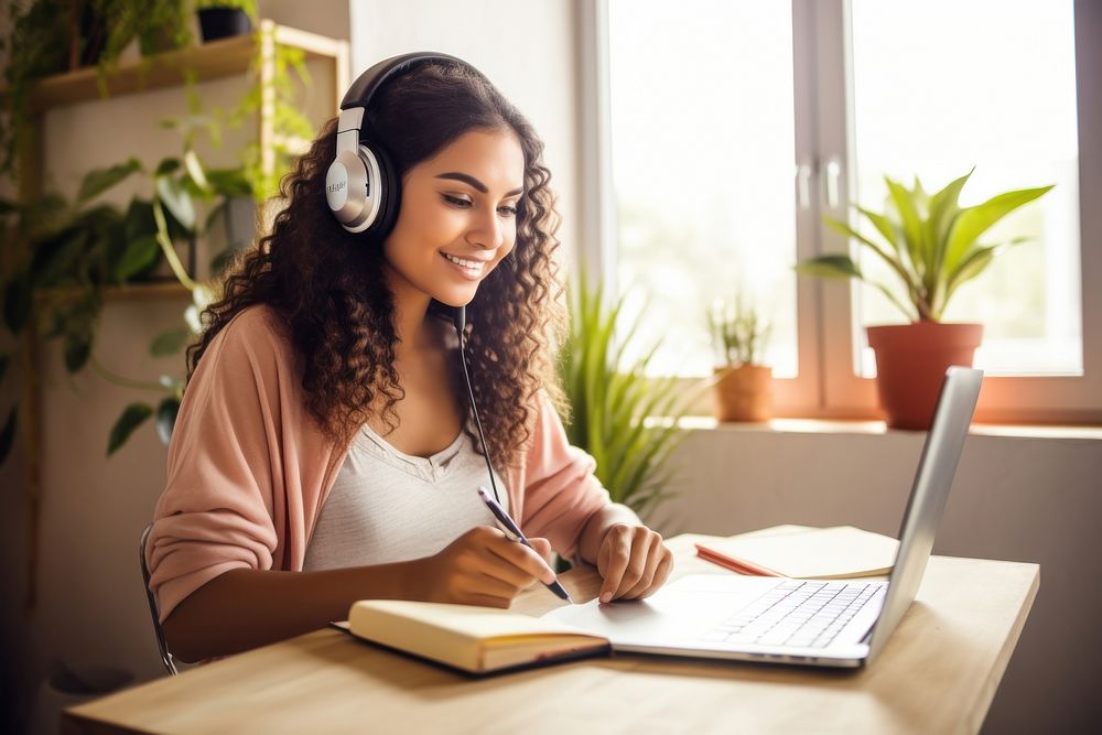 Latin woman learning online at home headphones writing listening. AI generated Image by rawpixel.