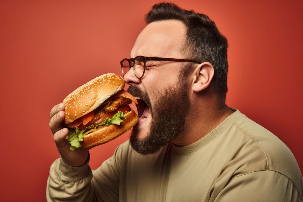 Eating hamburger biting adult food. AI generated Image by rawpixel.