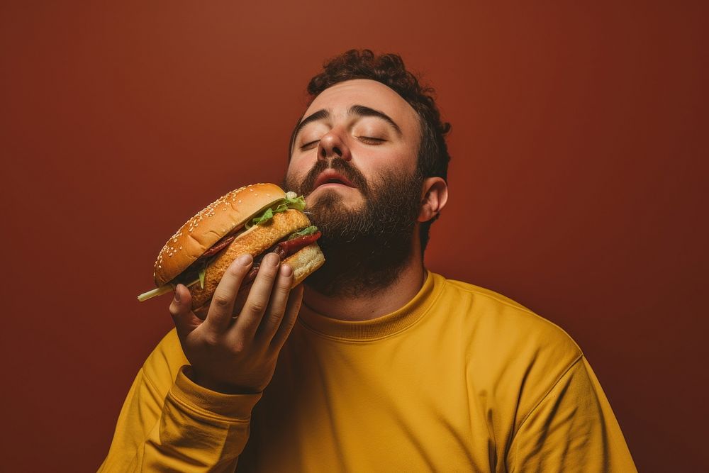 Eating hamburger sandwich biting adult. AI generated Image by rawpixel.