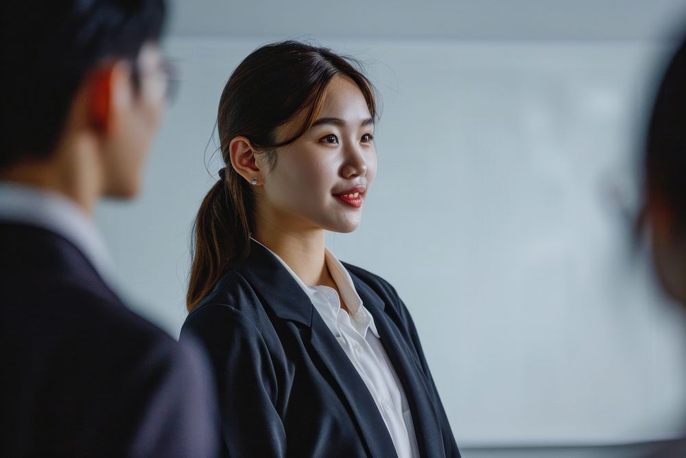 Asian business woman standing meeting talking. AI generated Image by rawpixel.