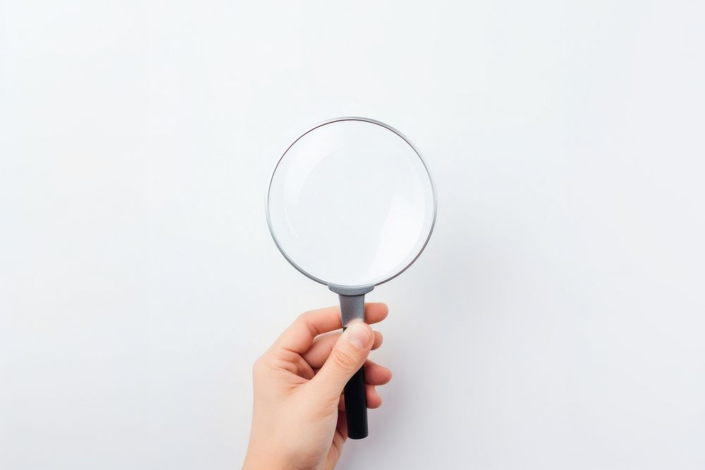 Hand holding a magnifying glass white background finger circle. AI generated Image by rawpixel.