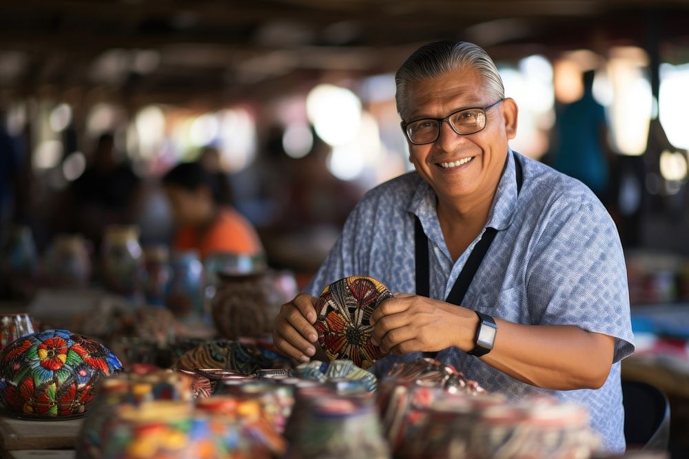 A Latino artist showcasing traditional crafts at a local market glasses adult man. AI generated Image by rawpixel.