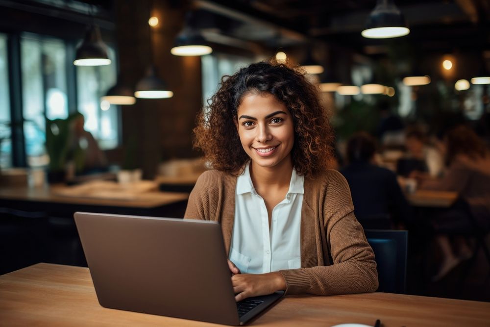 A young Latina entrepreneur working on a laptop in a office computer portrait adult. AI generated Image by rawpixel.