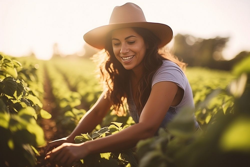 A young Latina farmer tending to crops in a sunlit organic farm agriculture gardening sunlight. AI generated Image by…