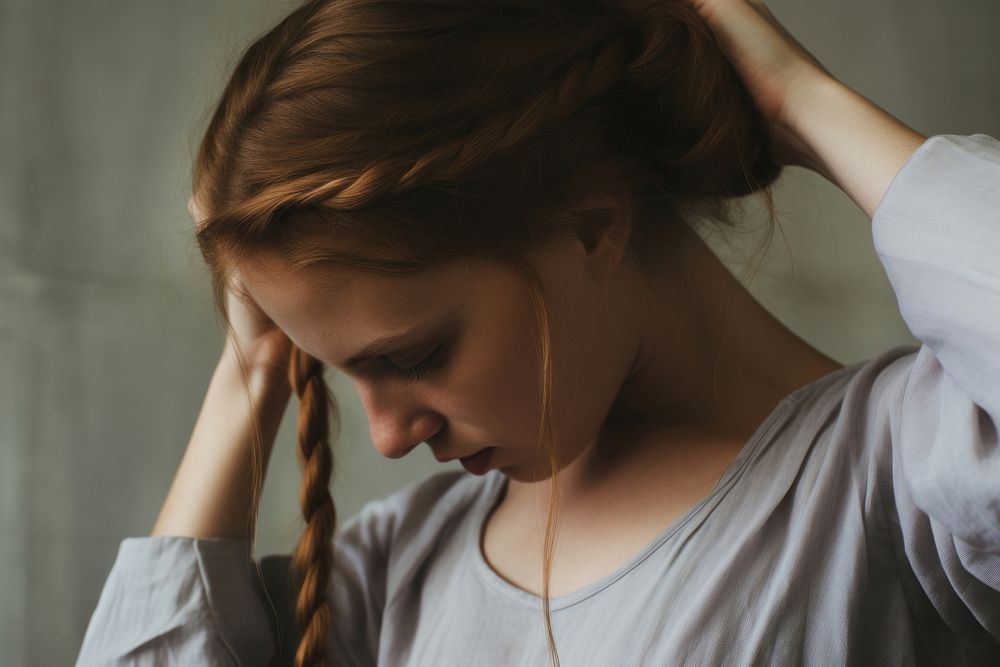 Girl tying hair worried disappointment contemplation. AI generated Image by rawpixel.