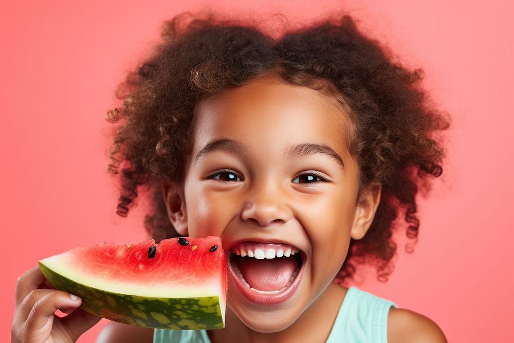 Girl biting watermelon child. 