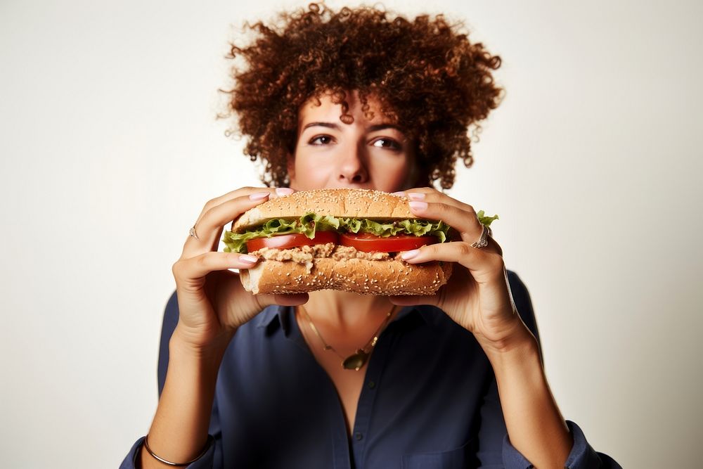 Girl biting sandwich eating. AI generated Image by rawpixel.