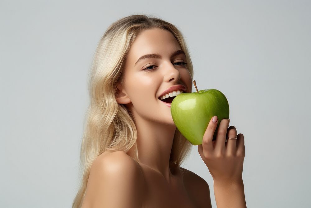 Girl biting apple eating. AI generated Image by rawpixel.