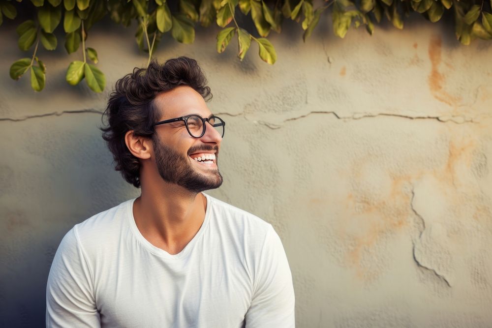Happy smiling man in glasses laughs at wall laughing adult smile. AI generated Image by rawpixel.